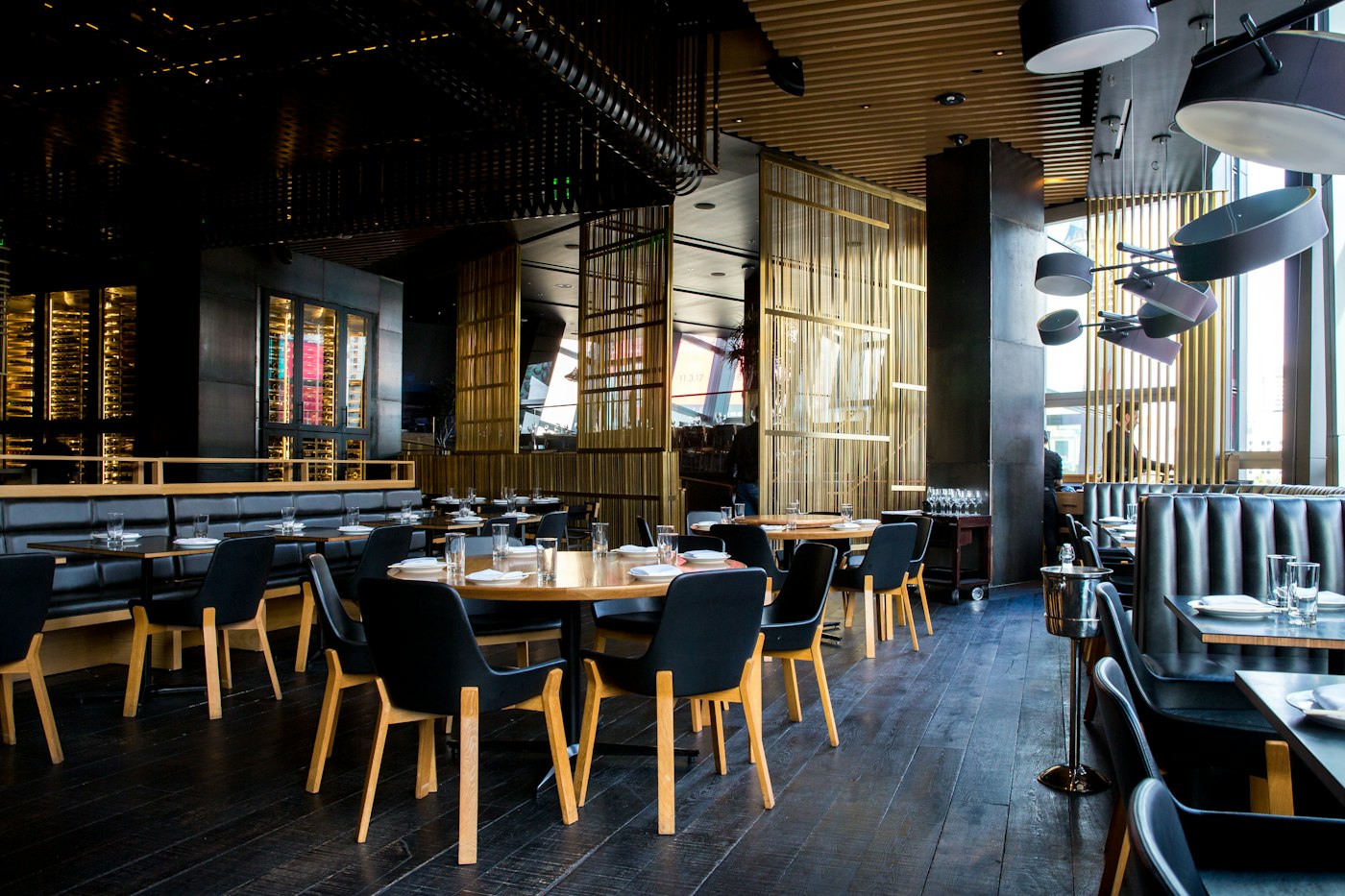 A restaurant dining room with tables set and chairs pulled in